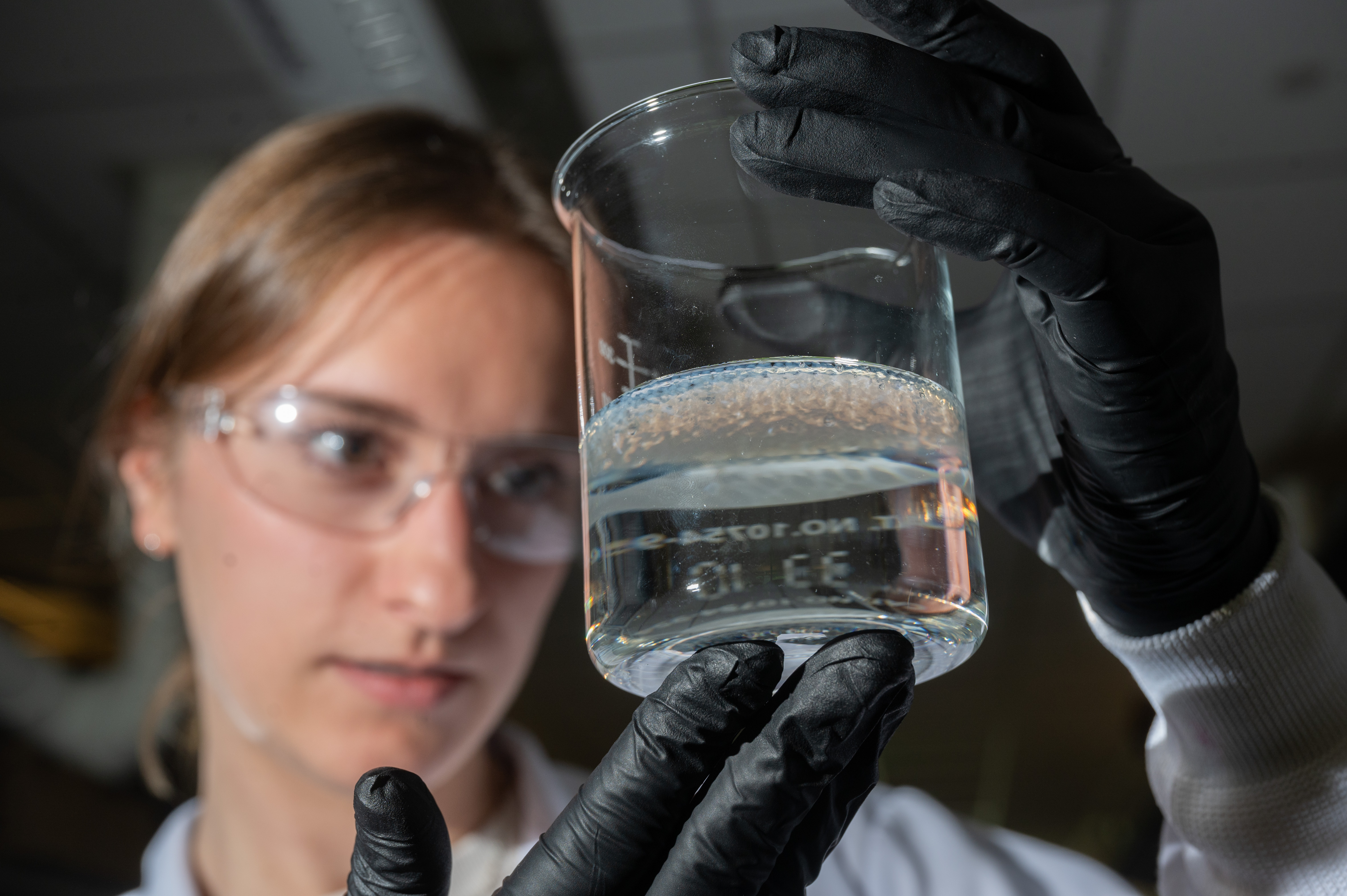 Woman looking at a beaker