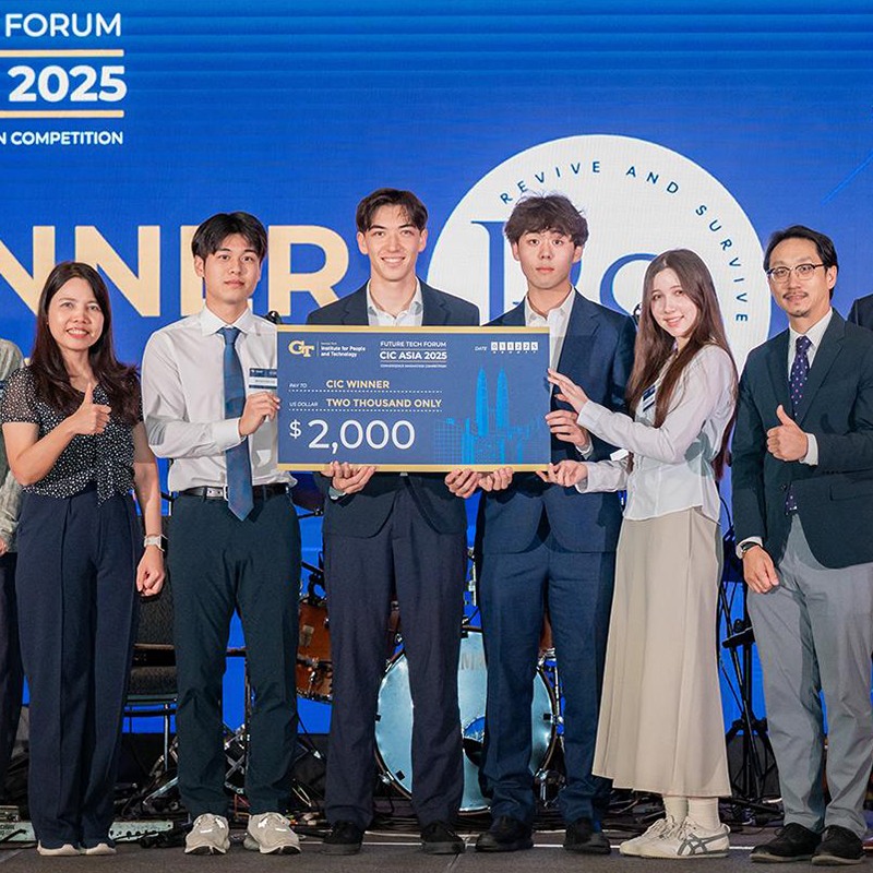Team receives first-place award at the CIC Asia 2025 competition, holding a $2,000 winner check on stage.