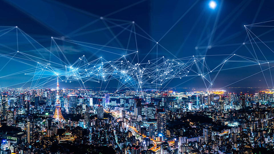 Night city skyline with illuminated buildings overlaid by interconnected network lines and nodes.
